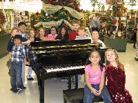 Students surround piano