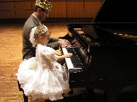 King and princess play piano together