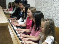 Five girls play one piano